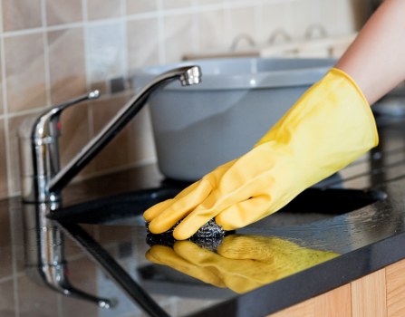 Technician carrying out hard floor cleaning on a tiled surface